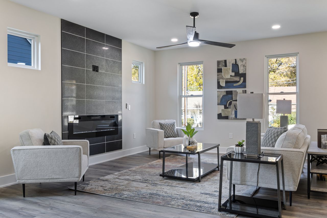 Home Stylish living room featuring a modern fireplace, sleek furniture, and artistic decor in a cozy setting.