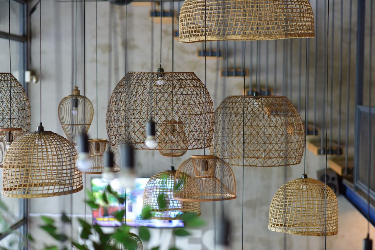 Stylish rattan pendant lights in a contemporary urban cafe interior, creating a warm ambiance.