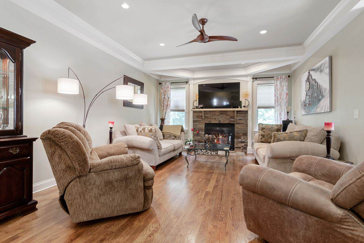 Home Spacious and elegant living room featuring contemporary furniture and a fireplace.
