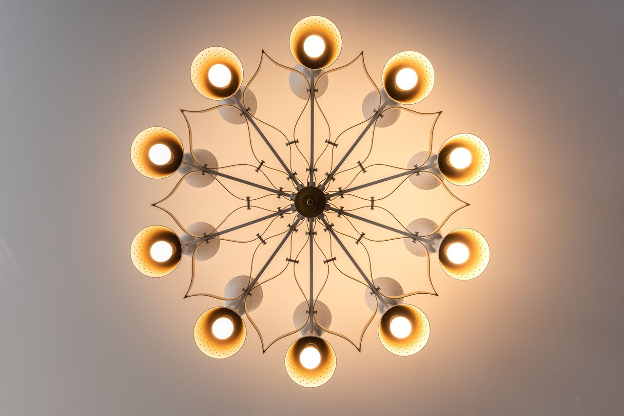 A stylish modern chandelier emitting warm light, viewed from below, perfect for interior design inspiration.